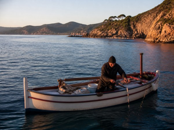 Un pêcheur sur son pointu au lever du jour